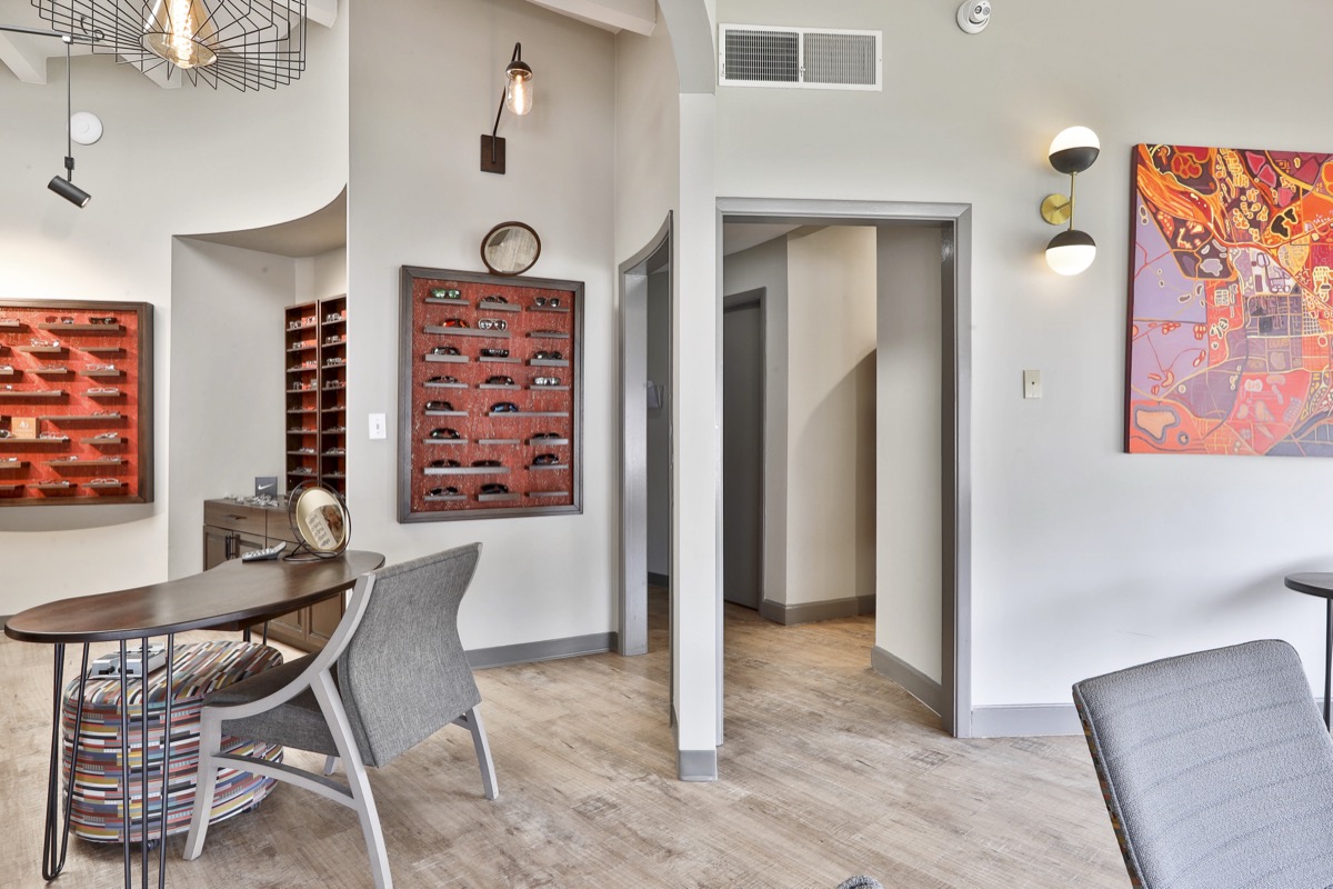 Boutique interior showing curved architecture and eyewear displays