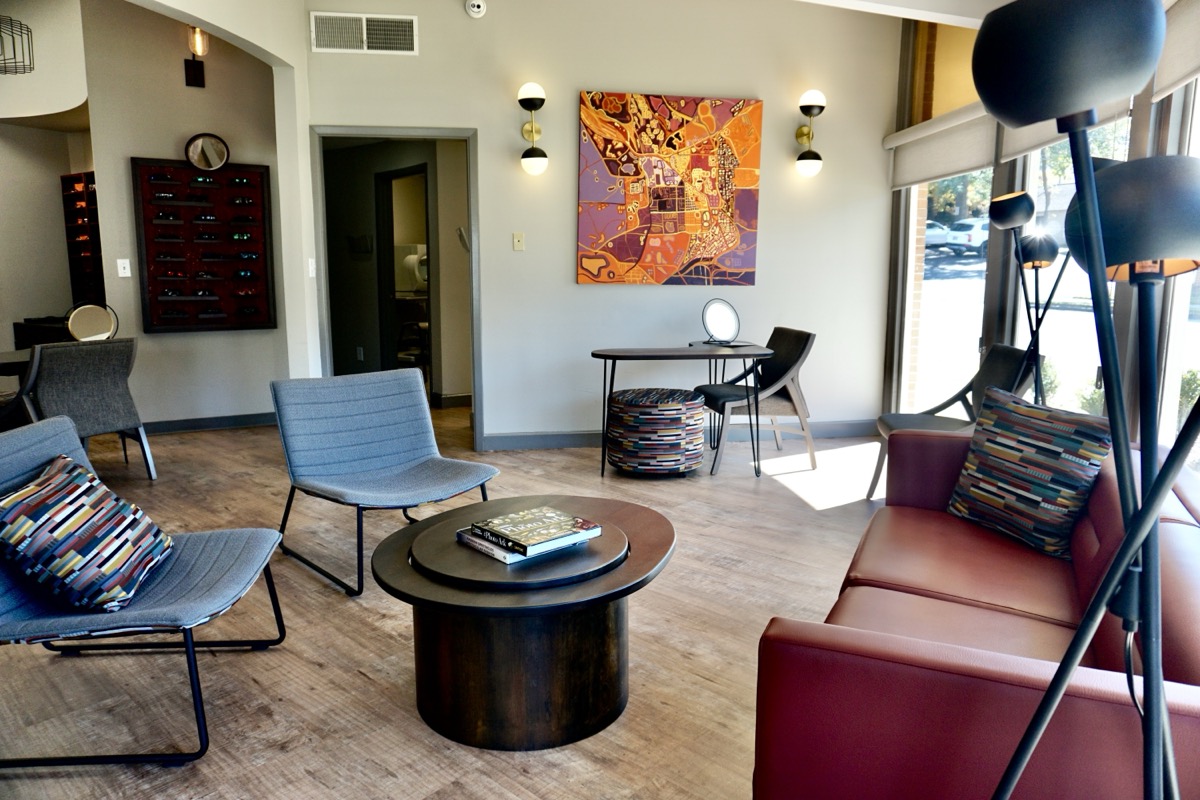 Elegant waiting area with modern designer furniture, colorful art, and natural light