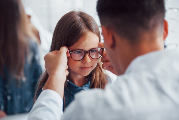 Child being fitted for eyeglasses